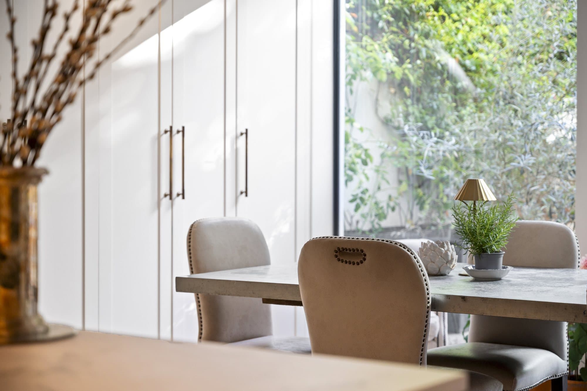 Kitchen island, staircase and garden beyond at Alma Terrace