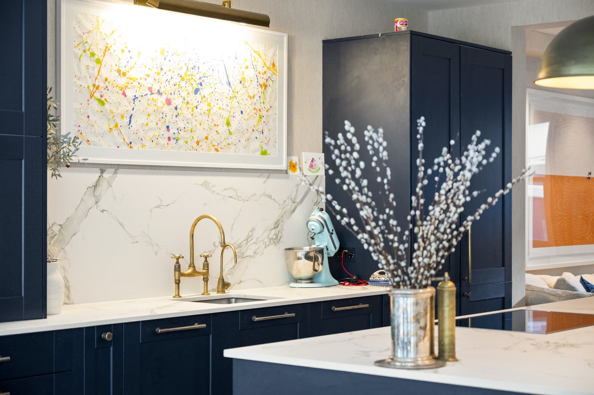 Navy kitchen with artwork above the counter