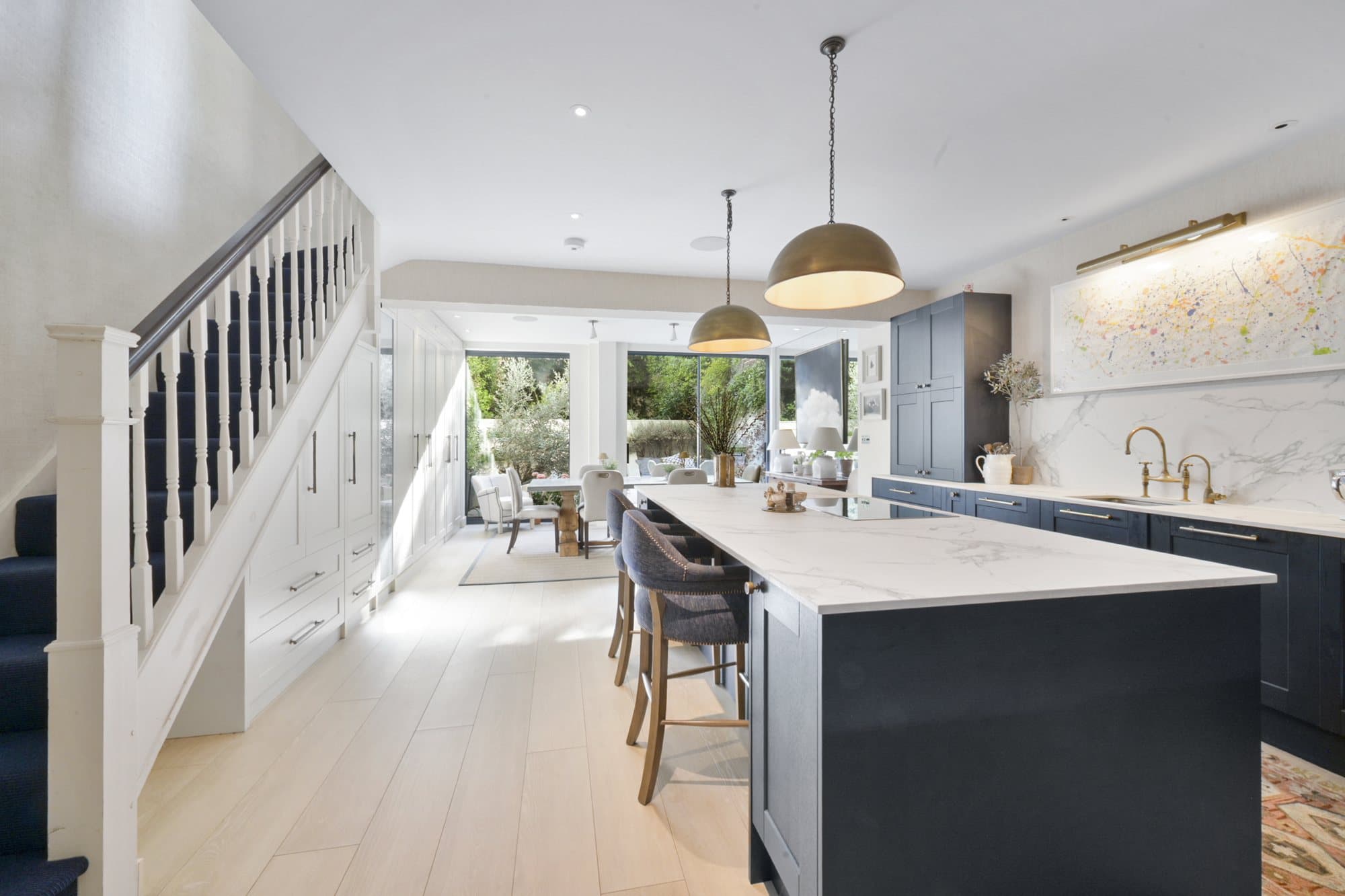 Kitchen island, staircase and garden beyond at Alma Terrace