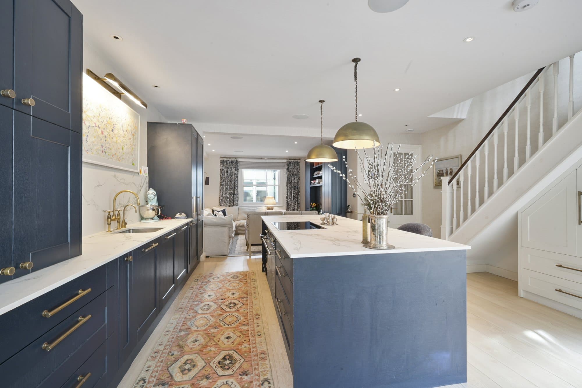 Kitchen island, staircase and garden beyond at Alma Terrace