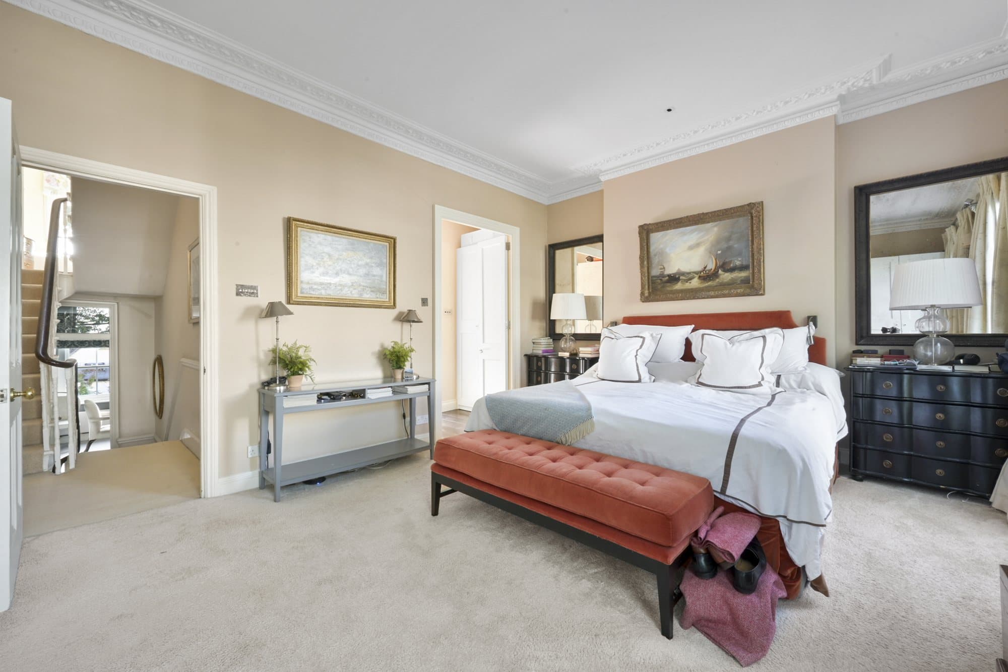 Bedroom with an upholstered bench at the foot
