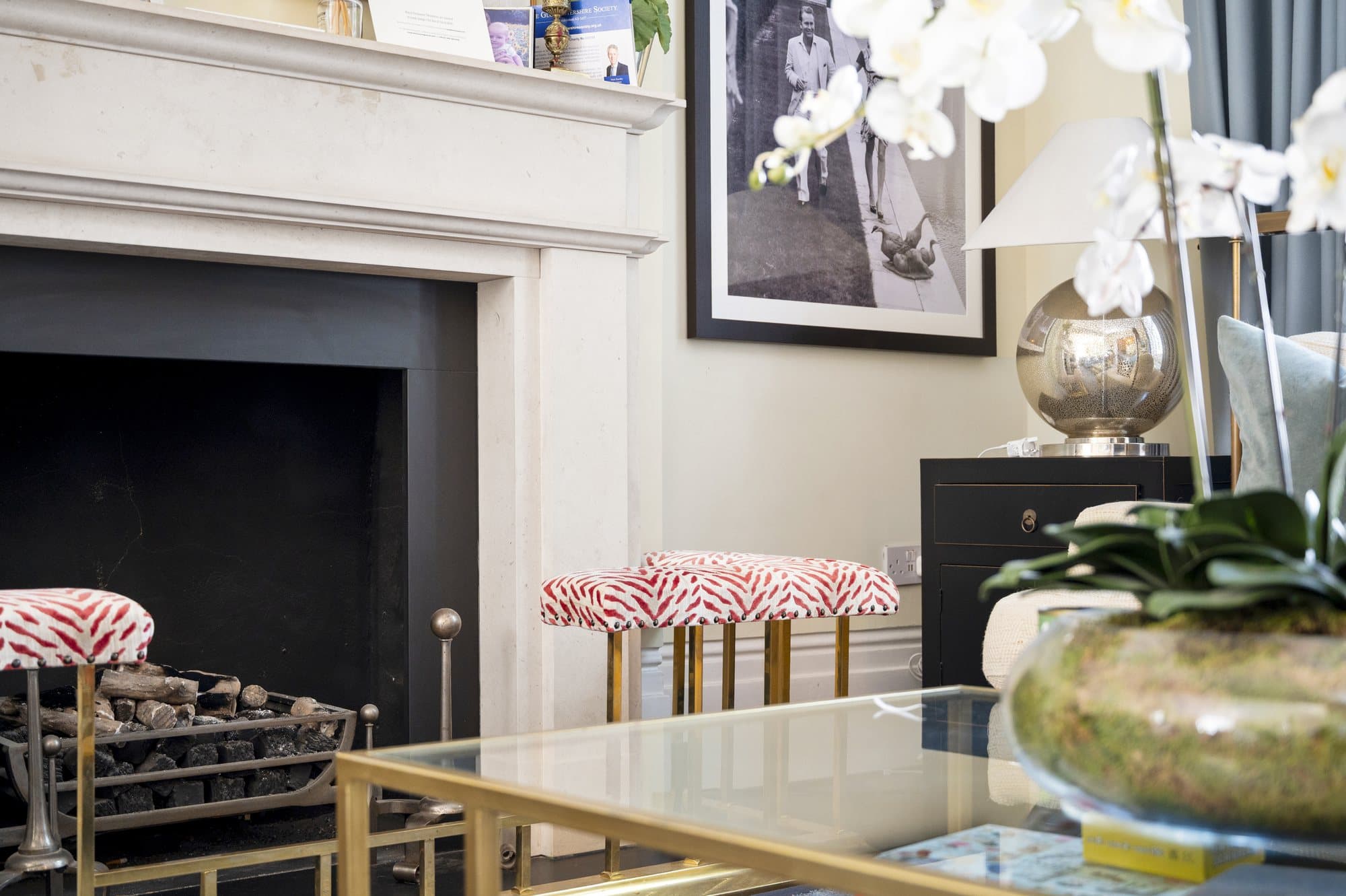 Fireplace with a brass and glass table