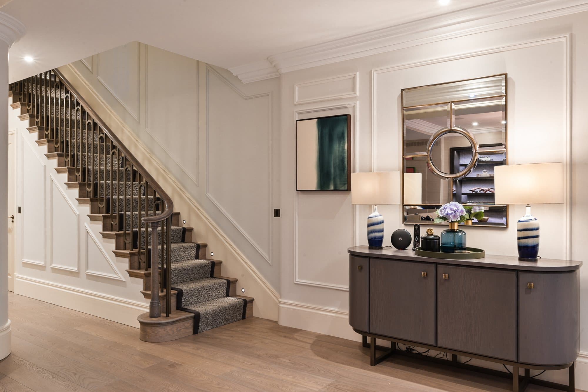 Staircase with sideboard and mirror