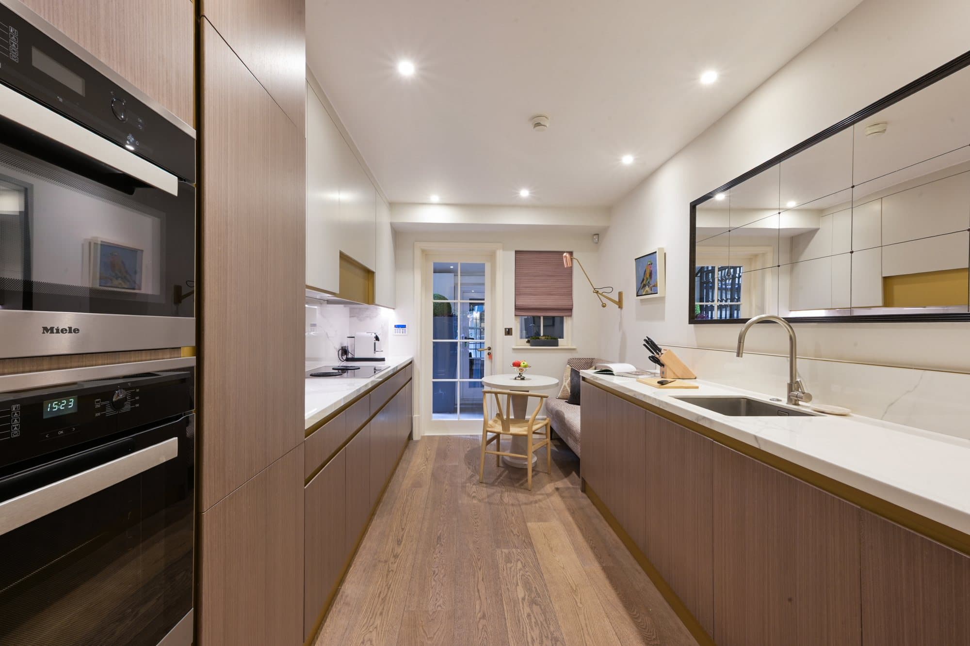 Kitchen corridor with dark cabinetry